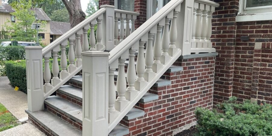 Front entrance stairs and raised back patio with custom masonry, showcasing design-build solutions and expert craftsmanship.