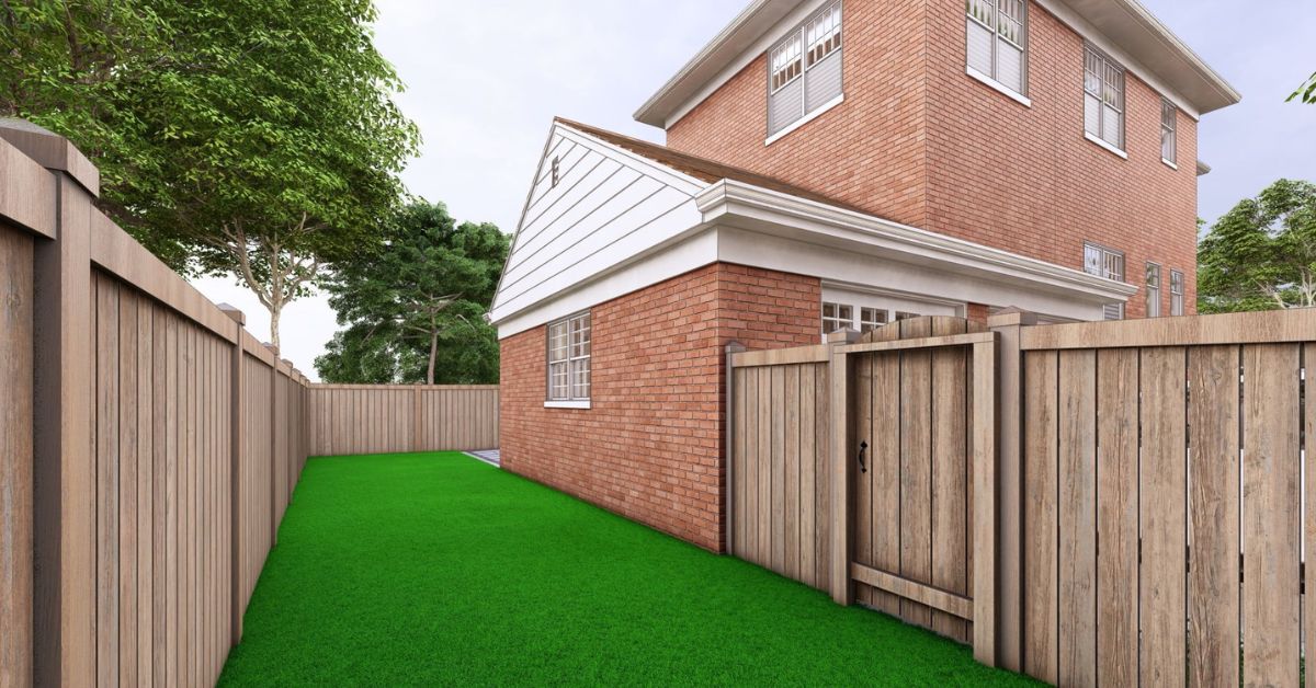 Evanston backyard renovation with Unilock patio, artificial turf, cedar fence, landscape lighting, and drainage system by Tommy Pollina Landscape Co. Inc.