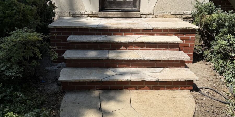 Hardscape renovation in Niles, IL with flagstone stairs, paver restoration, retaining wall cleaning, and stair lighting installation.