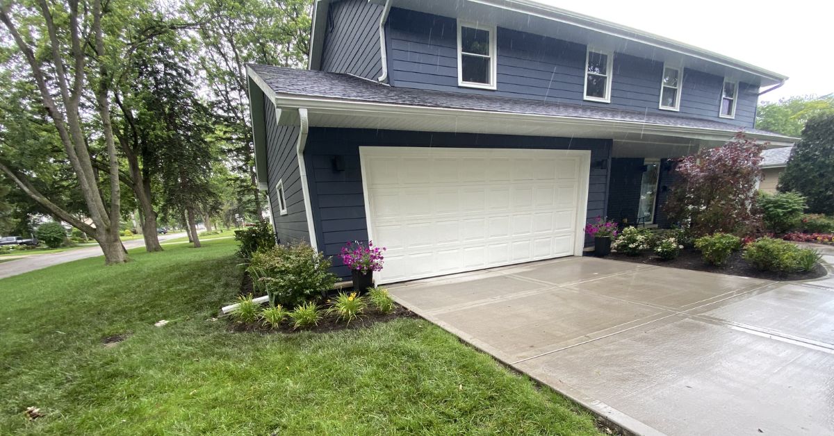 Landscape renovation in Northfield, IL with Japanese maple, hydrangeas, sod installation, PVC drainage, and new planting beds.