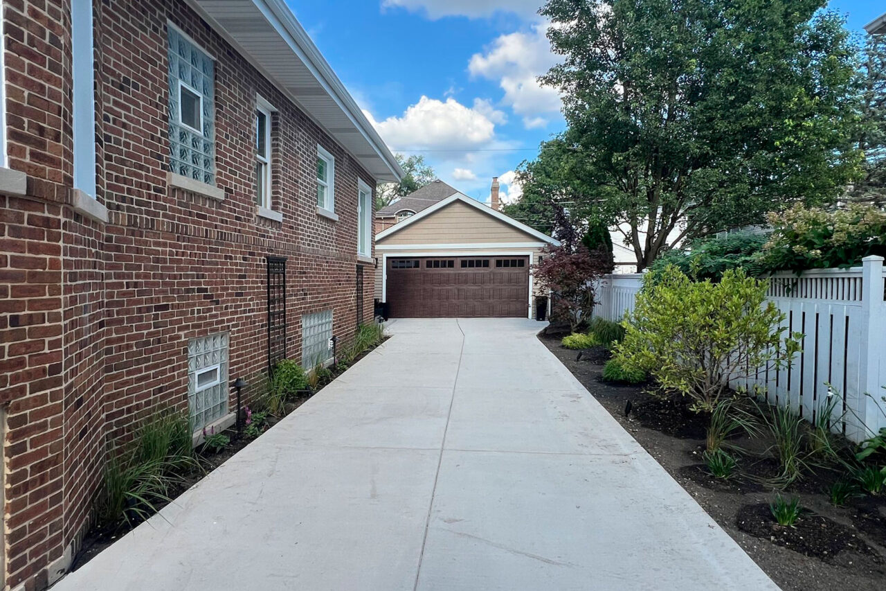 Complete outdoor makeover in Park Ridge with grading, NDS drainage, artificial turf, lighting, plants, and hardscapes