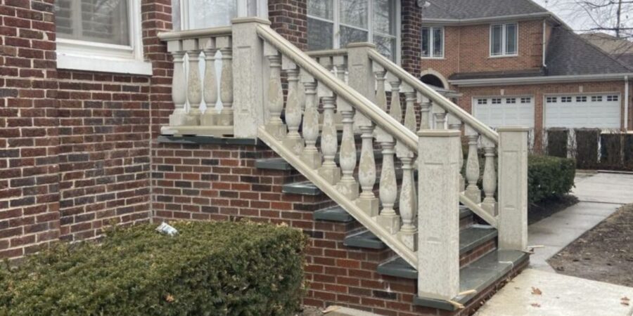 Front entrance stairs and raised back patio with custom masonry, showcasing design-build solutions and expert craftsmanship.