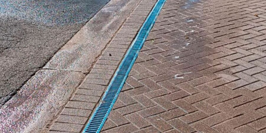 Riverwoods brick driveway with channel drain installed by expert crew, ensuring proper water flow and lasting drainage solution.