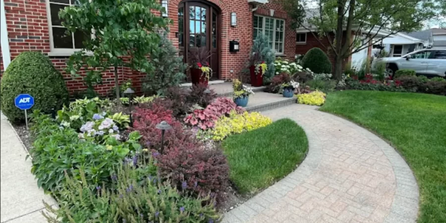 Cold-weather plant installation showing evergreens and shrubs arranged in a professionally landscaped Glencoe front yard.