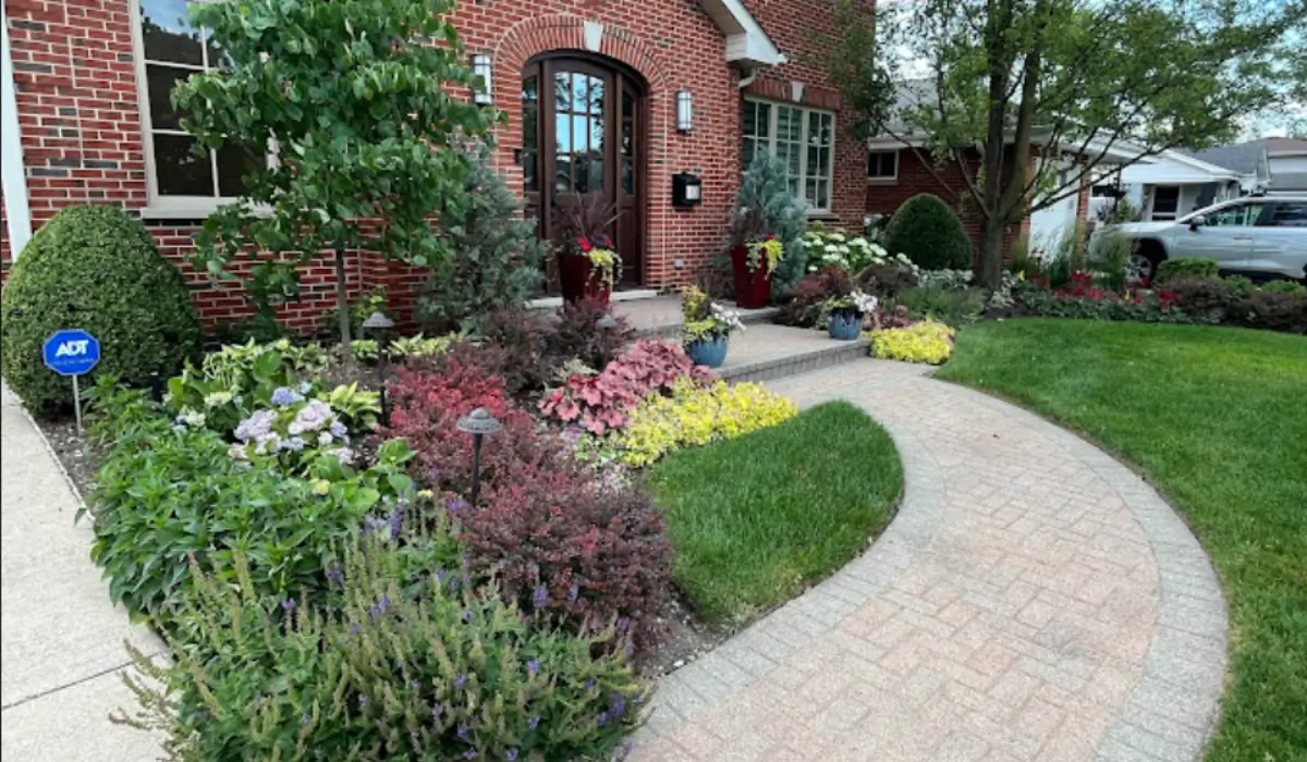 Cold-weather plant installation showing evergreens and shrubs arranged in a professionally landscaped Glencoe front yard.