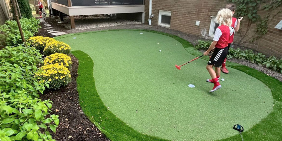 Glenview backyard with custom putting green installation providing family fun, golf practice, and outdoor entertainment.