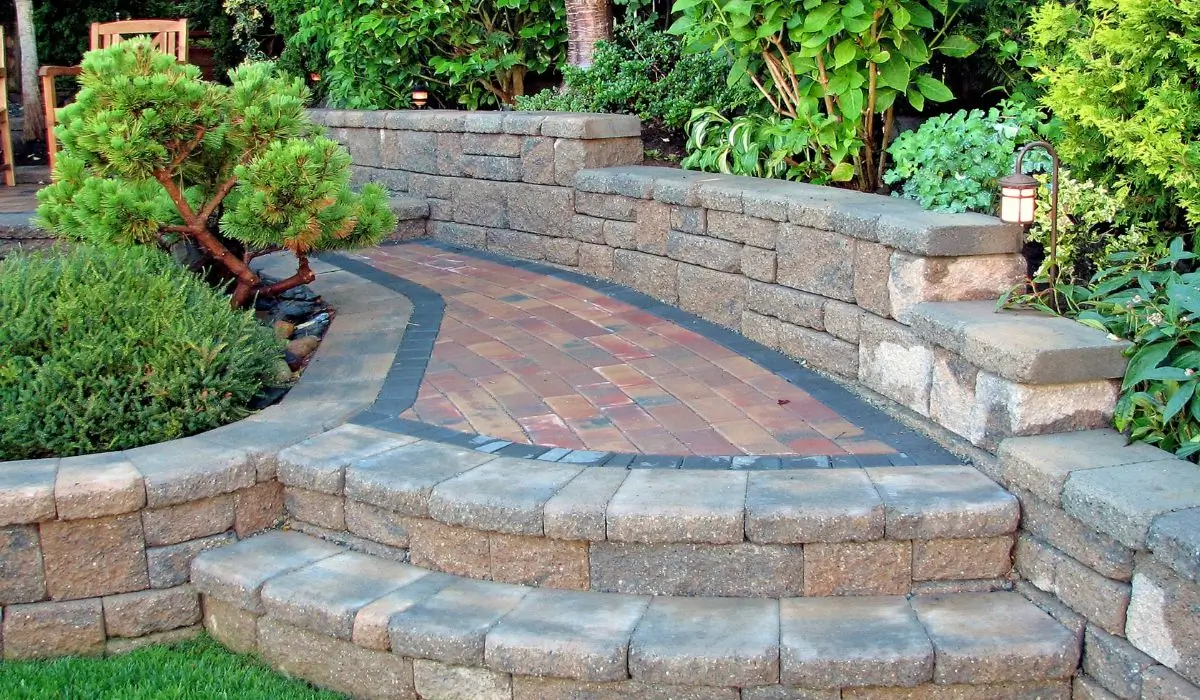 Brick and stone hardscape materials with steps and wall in Wilmette backyard.