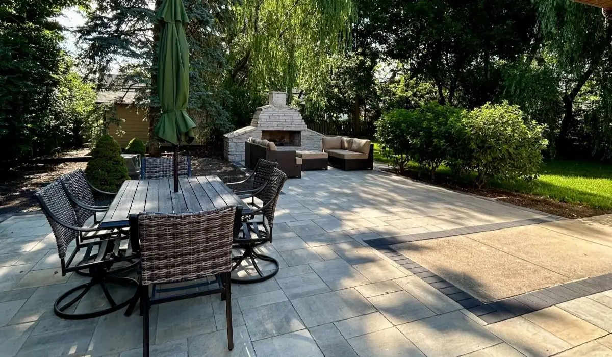 Modern backyard landscape design ideas featuring paver patio, built-in seating, fire feature, and mature greenery