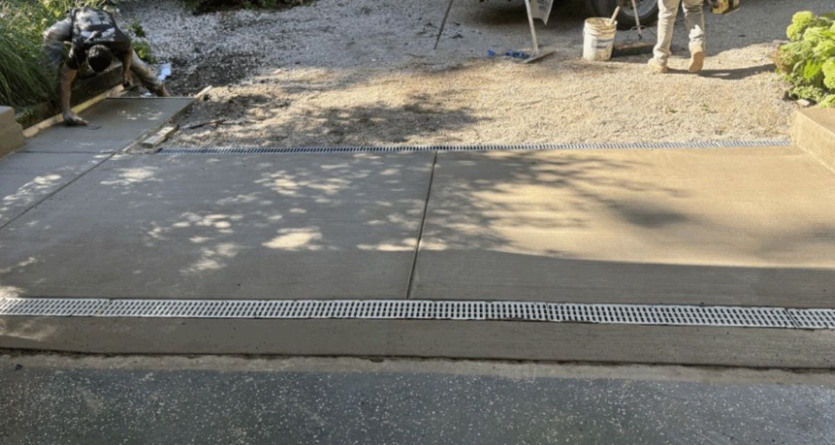 Riverwoods NDS drainage upgrade with new driveway, channel drains and rebuilt lines preventing garage and yard floods.