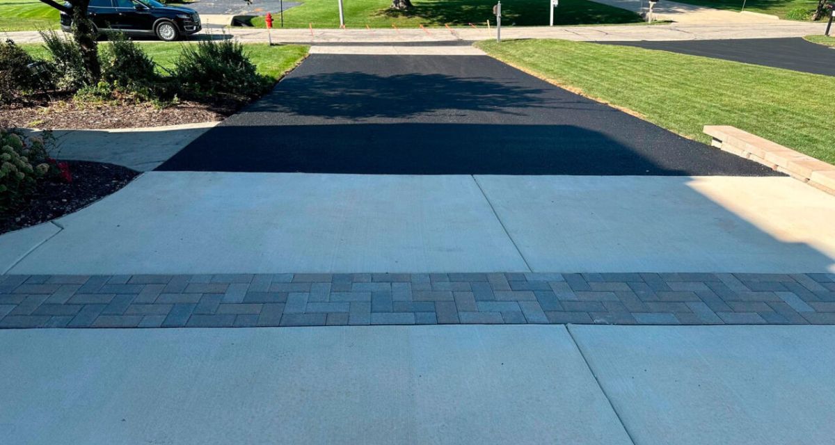 Schaumburg driveway reconstruction with asphalt, concrete, Unilock brick borders, retaining wall and Geo Grid.