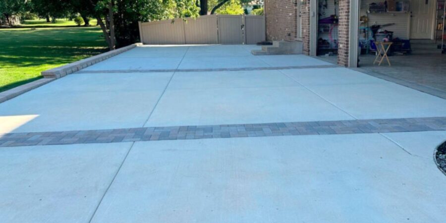 Schaumburg driveway reconstruction project with asphalt, concrete, Geo Grid, retaining wall, NDS drainage, and brick borders