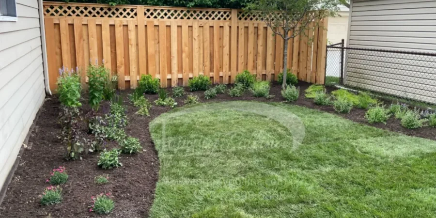 Spring landscaping featuring fresh mulch beds, new shrubs, and healthy lawn preparation before April.