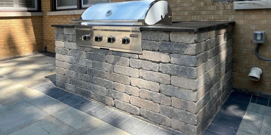 Winnetka backyard with new Bristol Valley pavers, charcoal border, rebuilt grill island, and limestone steps installed